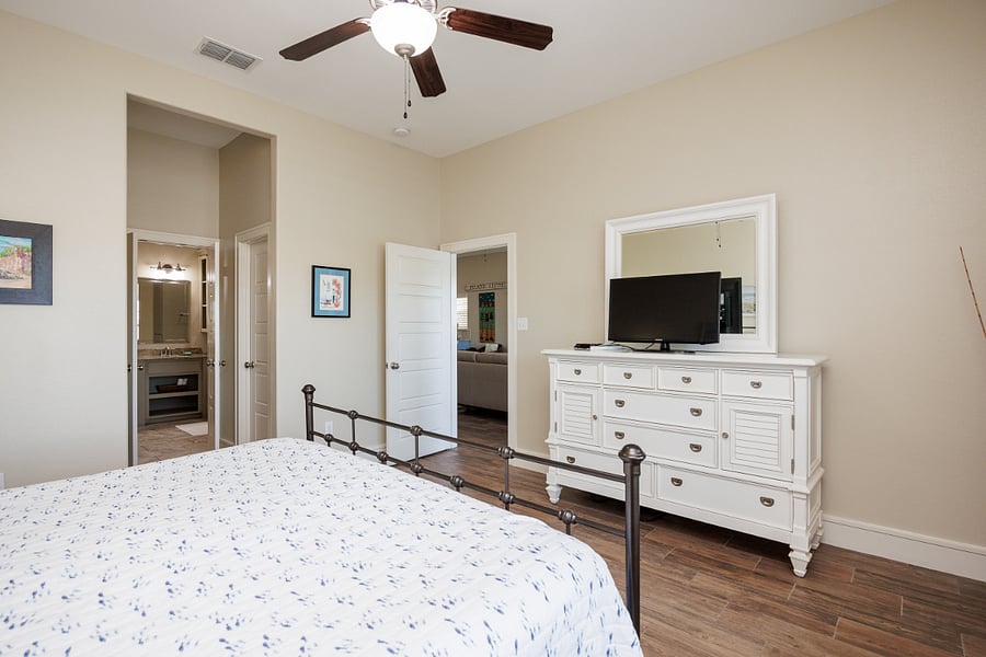 Primary bedroom with tv and en-suite bathroom.