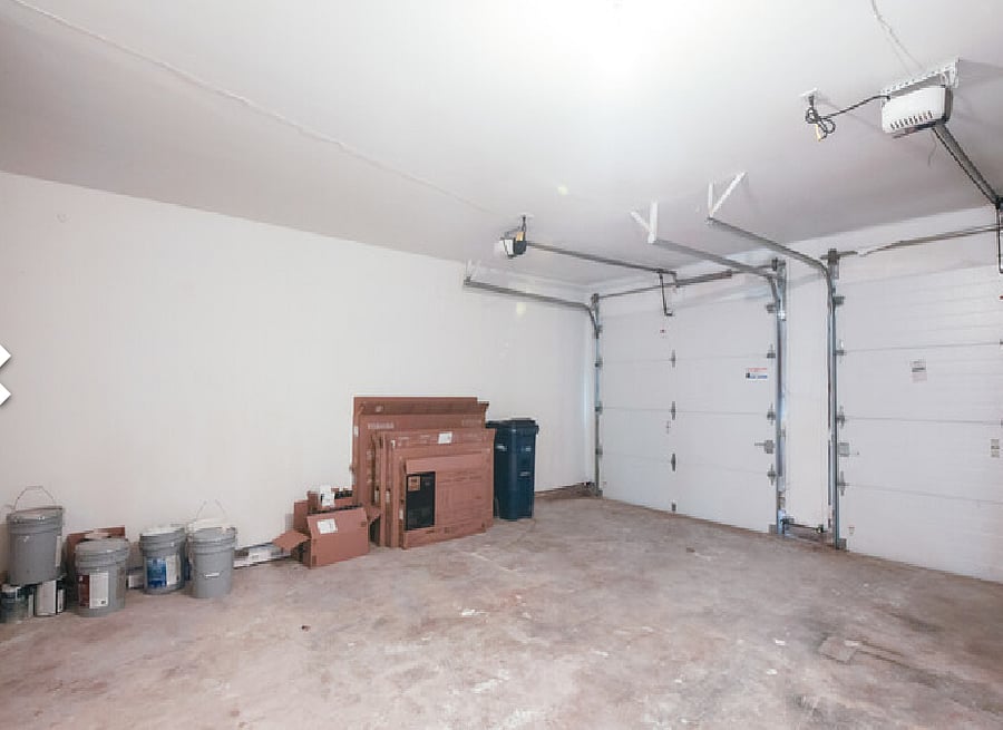 Garage with remote entry provides storage or secure parking for 2 vehicles