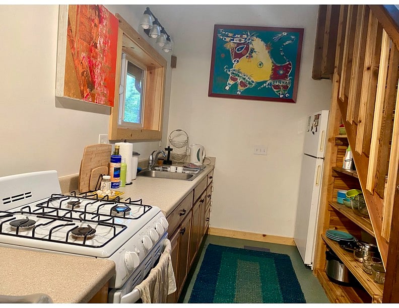 full kitchen well equipped with nice dishware, pots and pans.