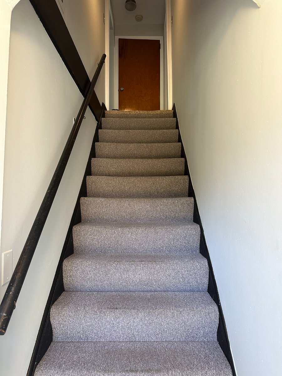 As you enter your private entrance, there is a staircase leading to your upstairs apartment.