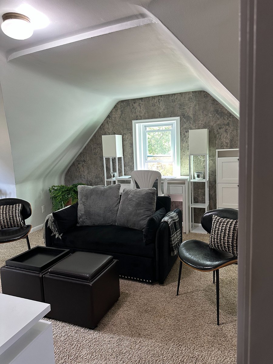 Living room offers sleeper sofa, extra storage, and seating. It also features a desk and chair for a dedicated workspace.