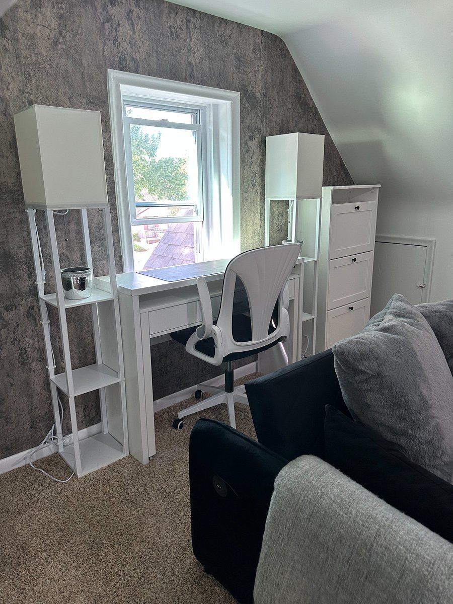 Dedicated workspace in the living room overlooking a lovely view of the front yard.  Desk expands to allow for more workspace. Shoe storage cabinet offers additional storage to keep everything neat and tidy in a small space.