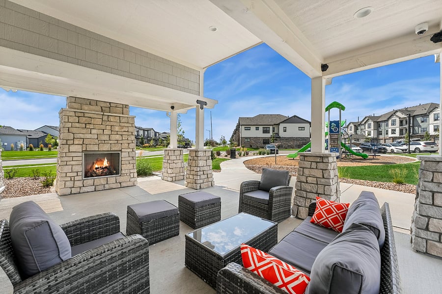 Clubhouse patio with communal outdoor furniture and a fireplace. Nice place to take in some fresh air!