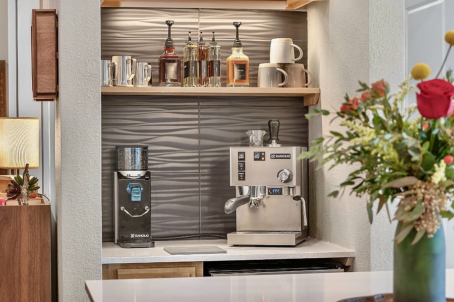 Good coffee is ESSENTIAL! Useless builder "coat closet" renovated into something more useful to get your days going. Espresso machine, grinder, separate hot/cold milk frother, hot water kettle, plus syrups and sauces for flavoring.