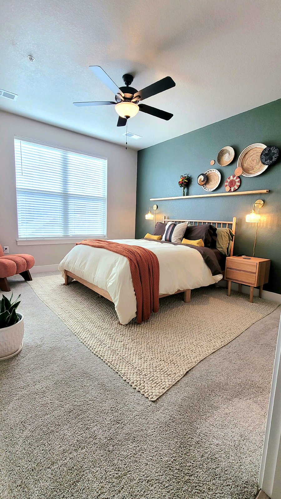 Primary suite with a queen bed, solid wood furniture, dimmable bedside sconces, cushy wool rug underfoot, plenty of outlets, and a relaxing BoHo touch. WIC (not pictured) includes hangers, storage bins, dressers, wood shelves, laundry basket. 