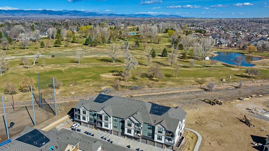 Aerial view of the "back" (South side) of the building with Fox Hill Golf Course steps away and the mountains in the distance. Entrance with stairs only on West end.