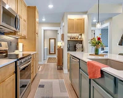 Kitchen that's fully equipped and spacious enough for two to cook. Dinner service for 8, pots, pans, bakeware, glass Tupperware set, cooking utensils, blender/smoothie maker, food processor, toaster, hand mixer, plus a few other small appliances.