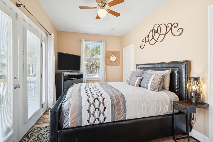 The primary bedroom has direct access to the back porch.