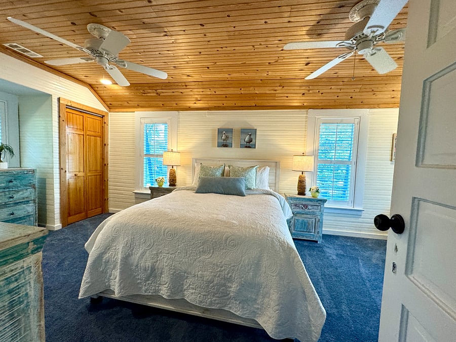 Primary bedroom with lots of space, premium bedding, and plantation shutters to let in the light...or not!  Large closet and lots of dresser drawer space for storage.