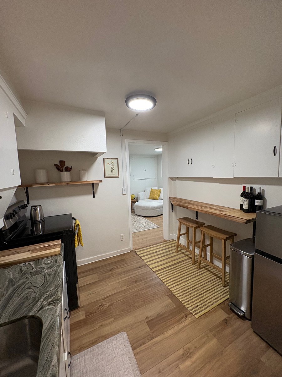 Opposite view of Kitchen. Tons of cabinet space and bar area.