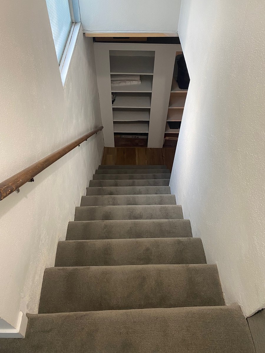 Stairs leading down to apartment from landing.