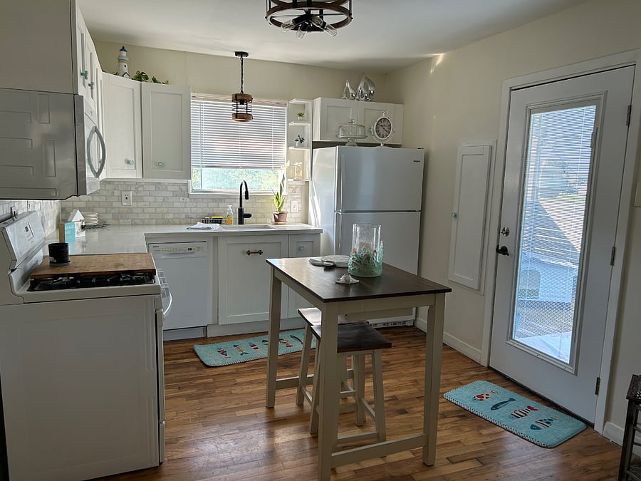 Full kitchen with refrigerator and icemaker