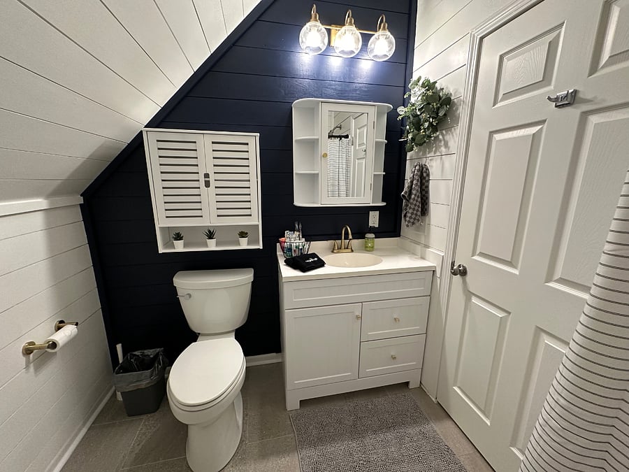 Upstairs full bathroom with starter toiletries, hair dryer and tub/shower.