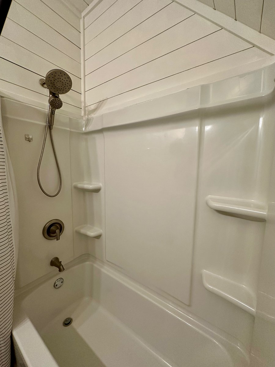 Shower in upstairs bathroom with handheld and shower option.