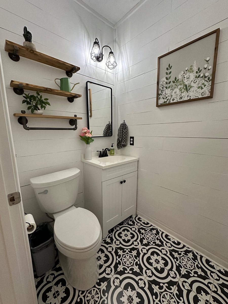 Downstairs half bathroom with starter toiletries and hair dryer.