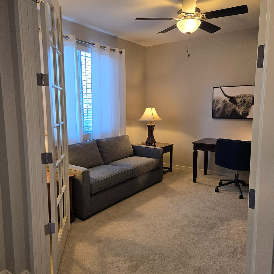 Just inside the front door and well separated from the rest of the house, is a den/office with a desk and new smart TV.