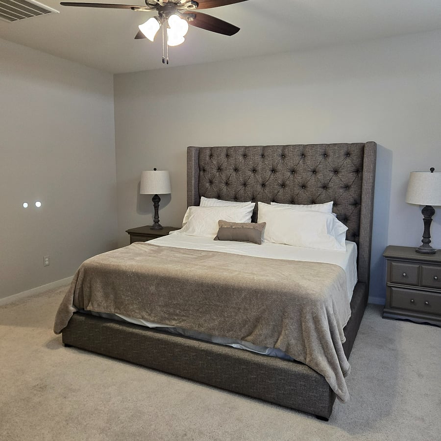 Primary bedroom with king bed and views to the backyard.