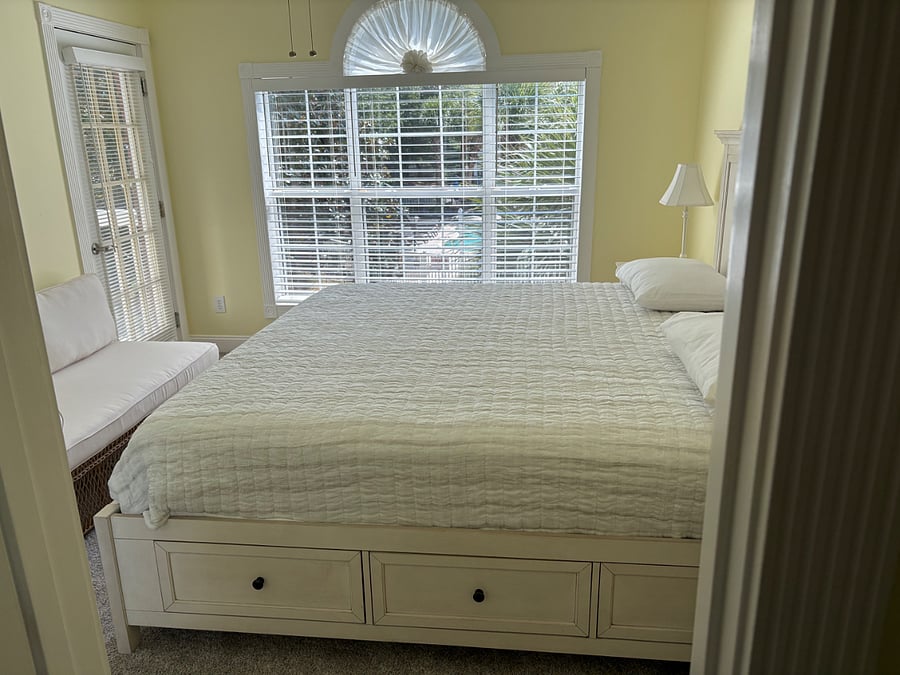Master bedroom overlooking pool, with a private door to patio.