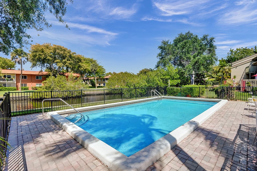 Pool with sun deck sitting against Middle River
