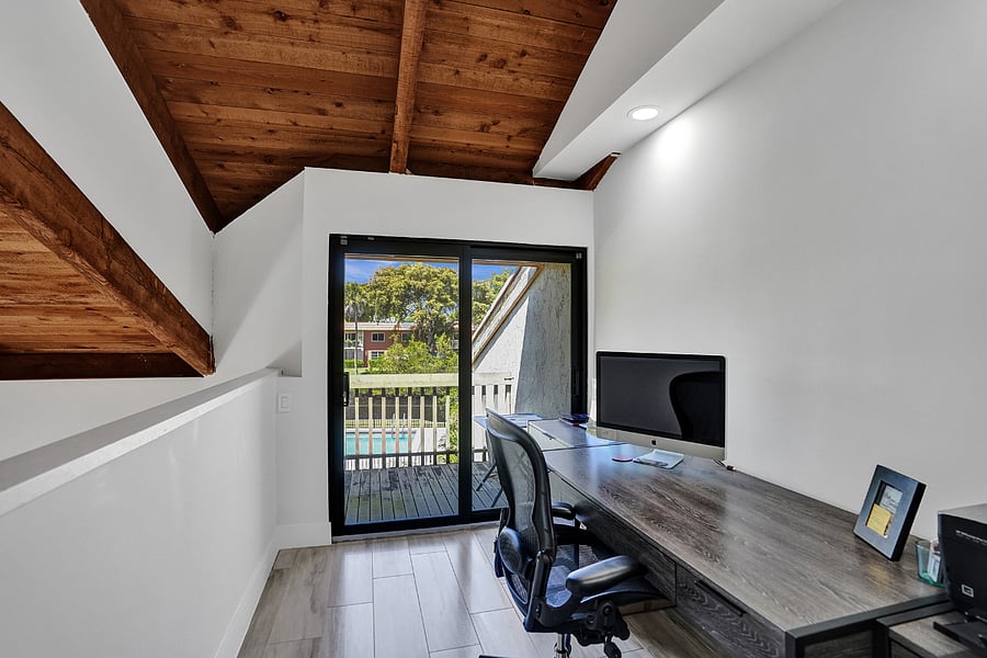 Office with balcony over looking Middle River and the pool.