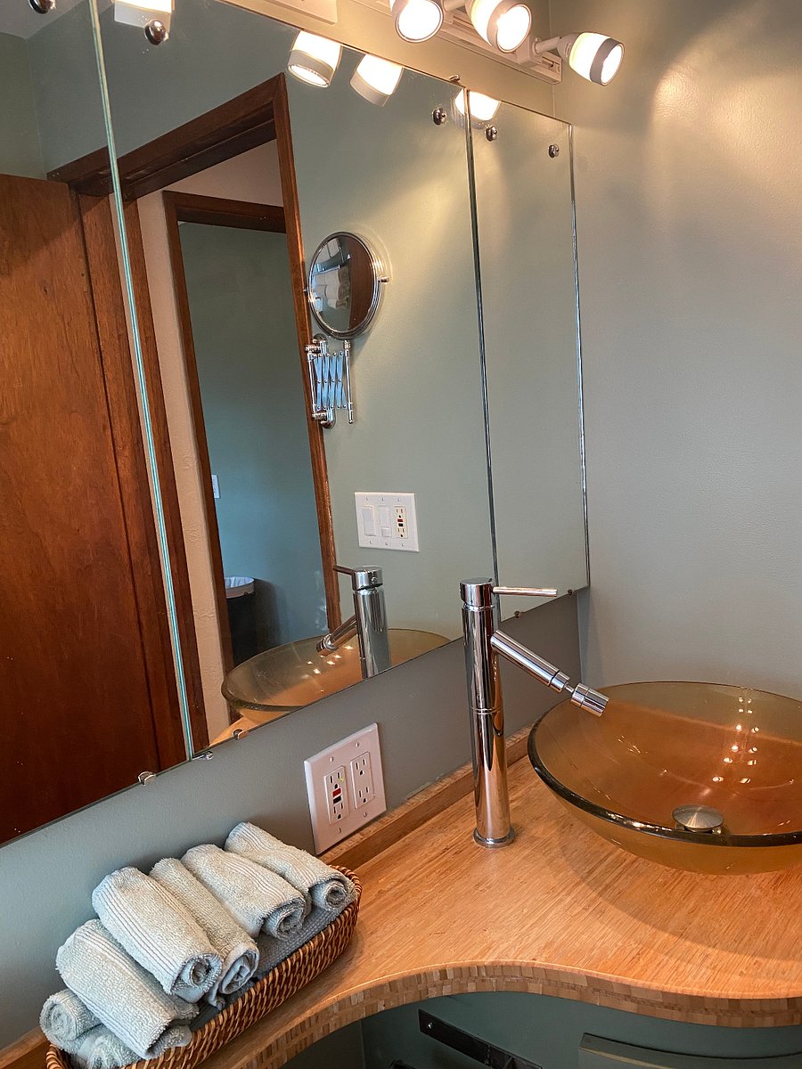 Bathroom mirror has storage shelves inside