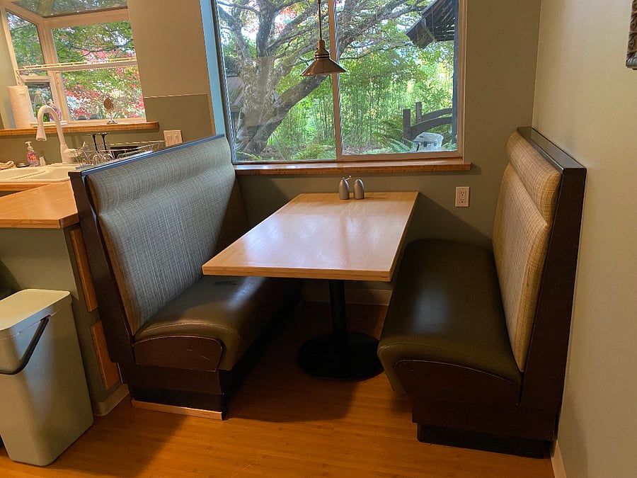 Comfortable cafe booth with handmade bamboo table