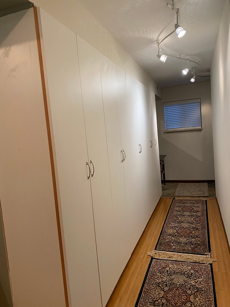 Closets with shelves line the entryway.