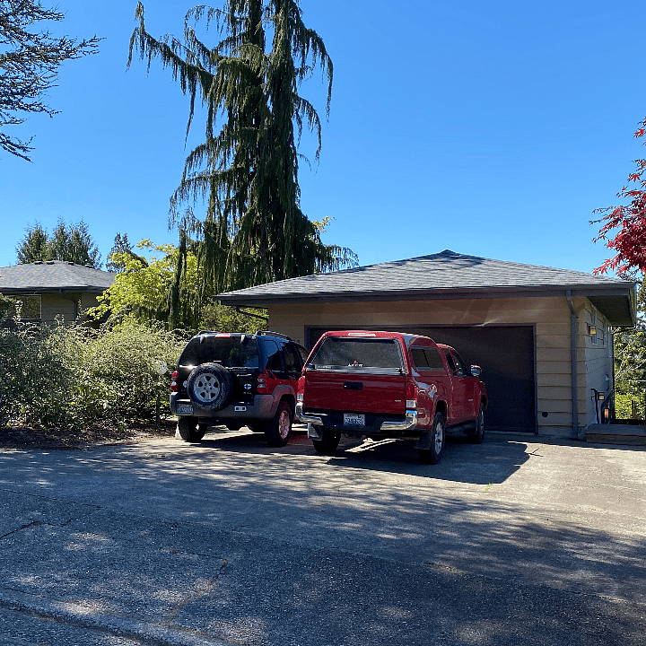 Driveway, garage and house. Guest parking is on the right.