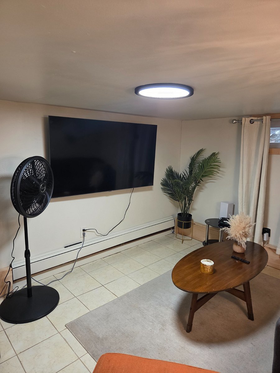 Living room with 65" Smart Samsung TV, Fast speed Fios (Verizon) internet, Standing fan.