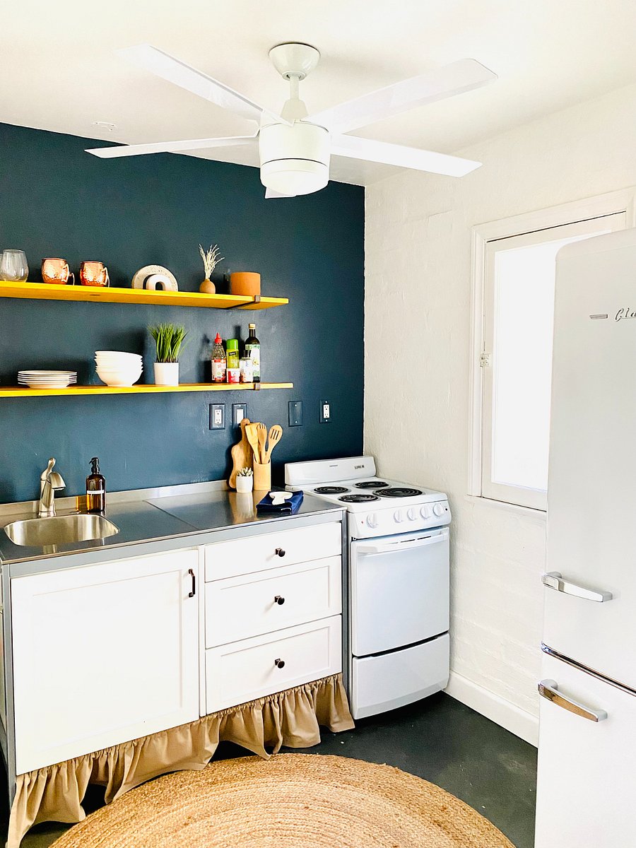 Well-stocked, restored vintage kitchenette with apartment sized retro refrigerator.