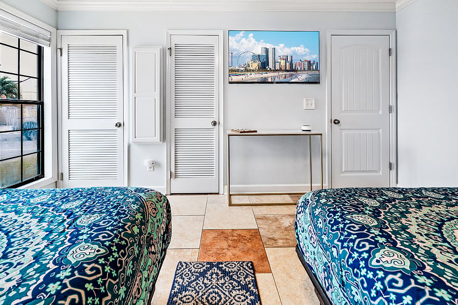 This room also has a Smart TV, an ironing board, and closet.