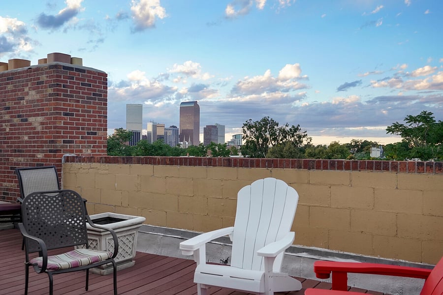 Great rooftop deck, with chairs, tables and a grill