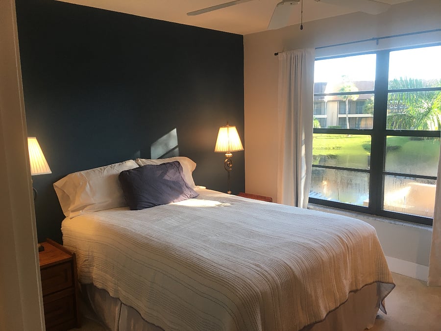 2nd bedroom with blackout curtains and a walk-in closet