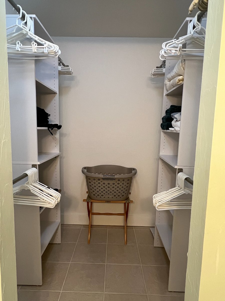 The primary walk-in closet has updated shelving and plenty of storage space