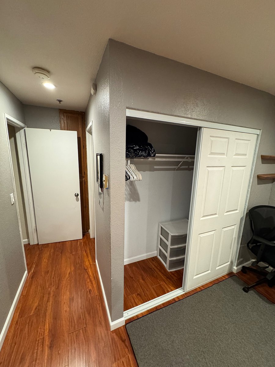 Master bedroom closet. Door to the leads to the living room. You can't see it but there is a door on the right, behind the closet leading to the bathroom.