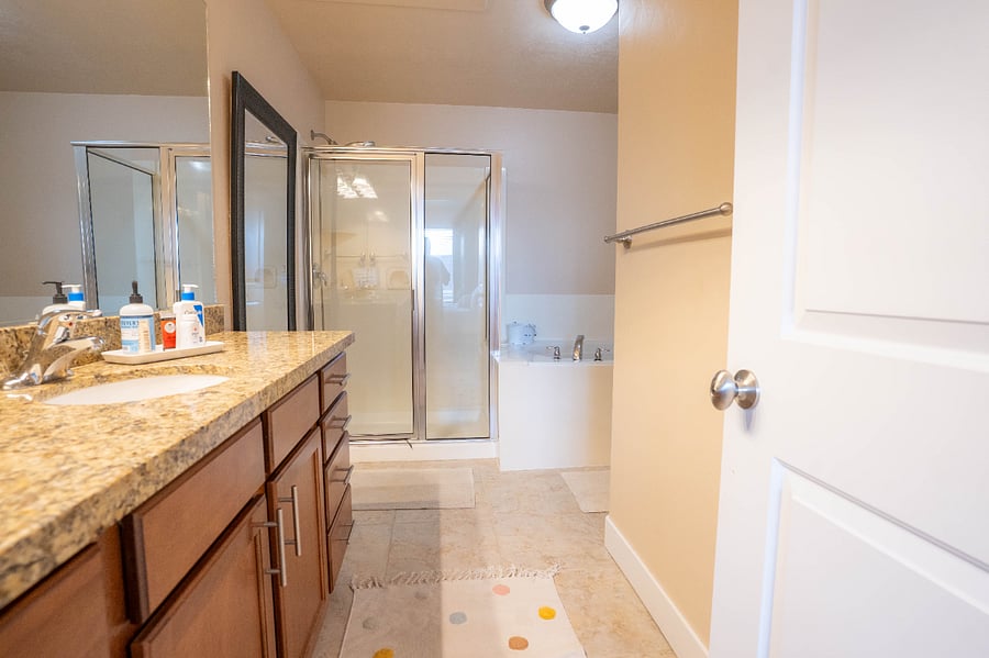 Primary private bathroom with large tub and shower