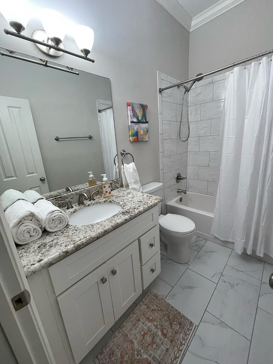 The hallway bathroom. This is a full bathroom featuring a tub with a showerhead.
