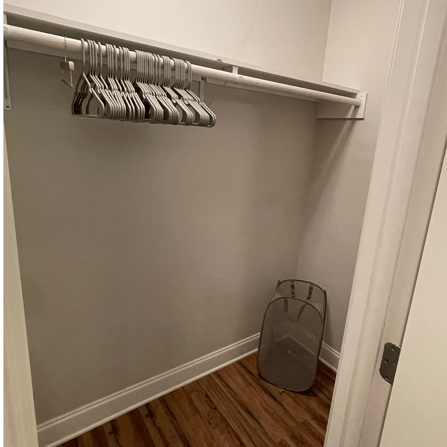 This closet is accessible through the main bathroom. Closet hangers and laundry hamper are included with the unit.