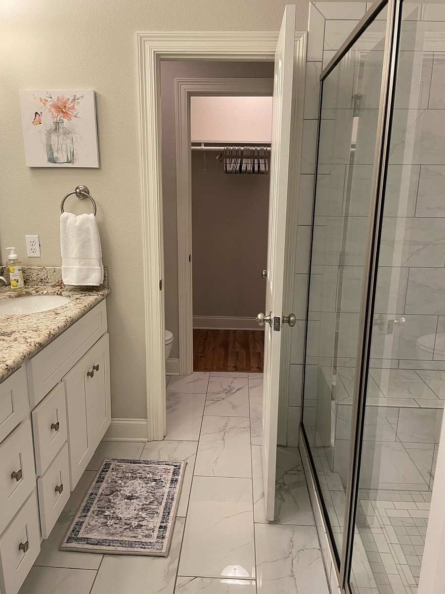 In the bathroom, a door leads to the toilet room, and beyond that room is a large closet space.