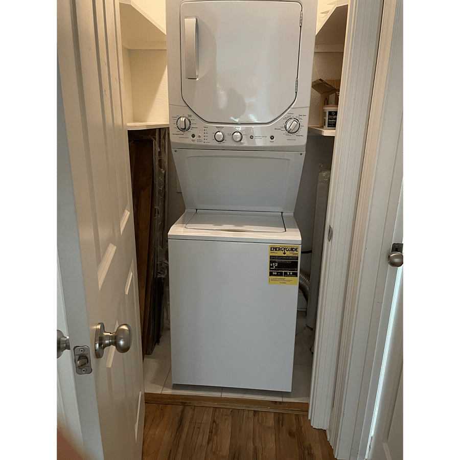 Laundry room that sits between the second bedroom and office. The washer and dryer are one combo unit with the washer on the bottom and the dryer on top.