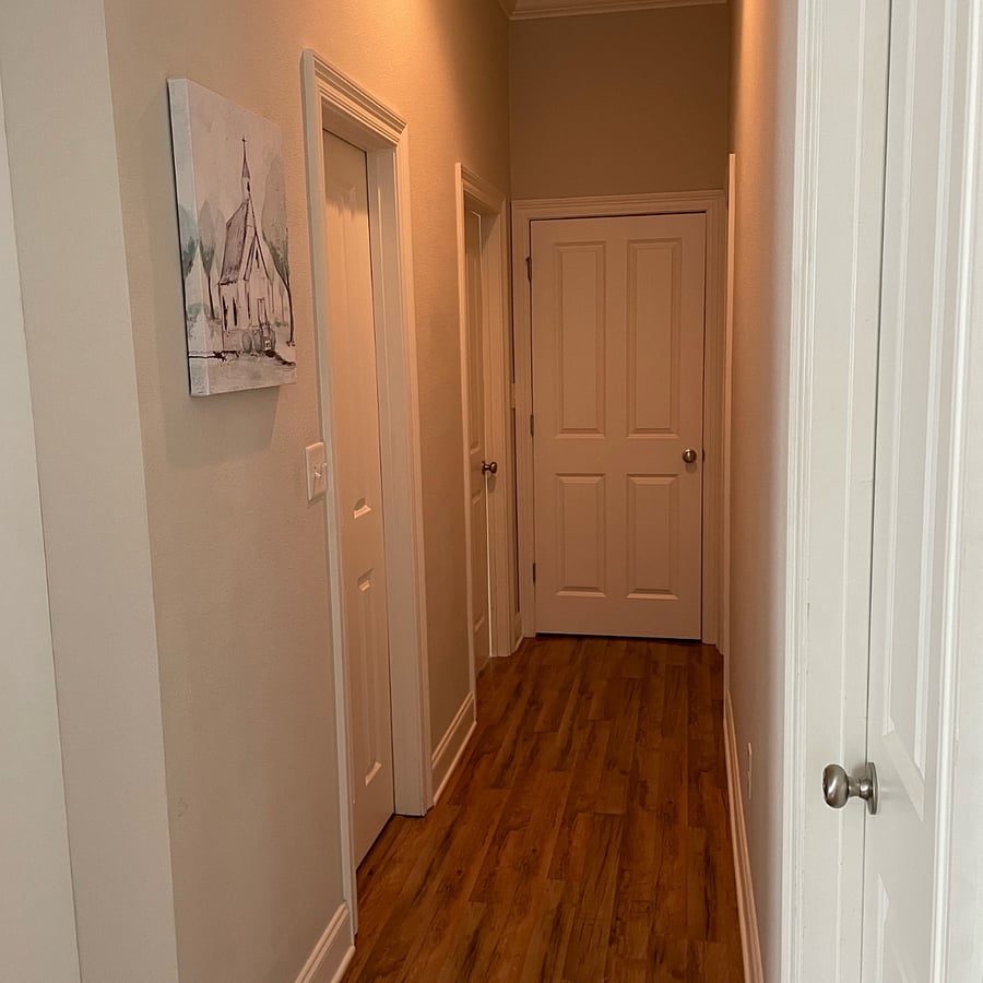 Hallway. The first door on the right is the front bedroom. The first doorway on the left is the hallway bathroom.