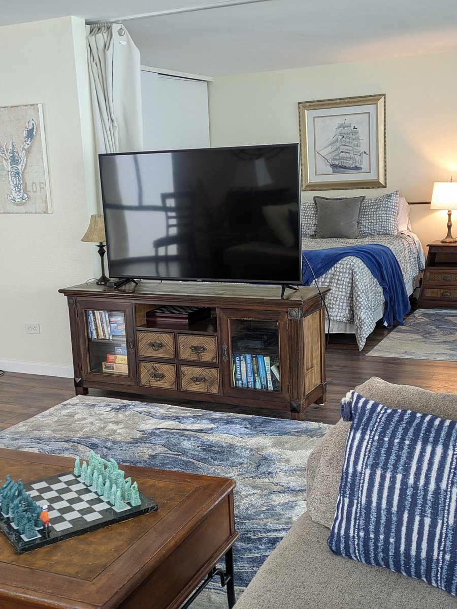 Living room 55" Smart TV and view into Queen bedroom Bedroom