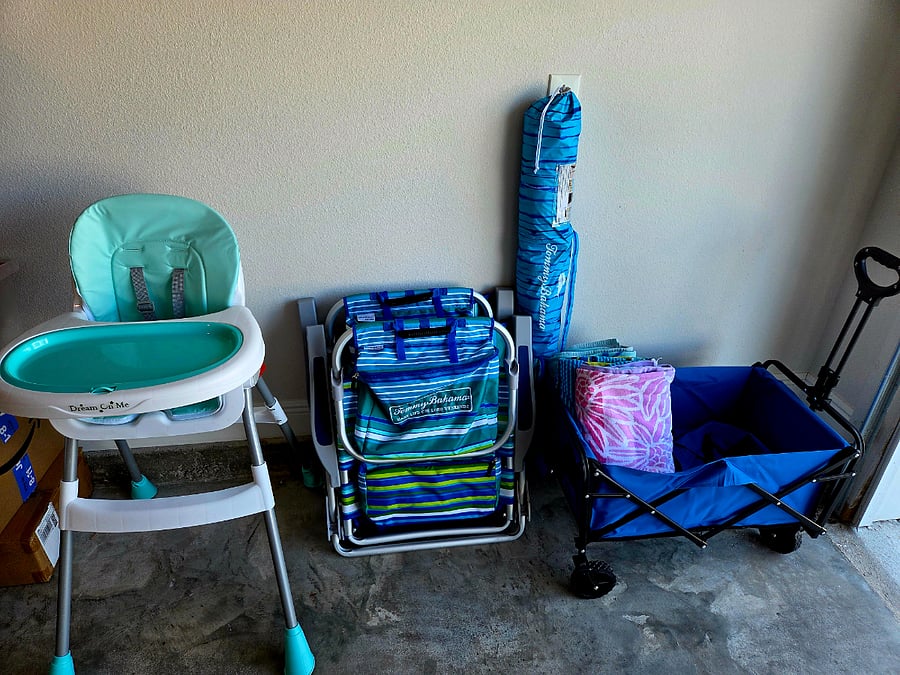 Highchair, pack n play, beach buggy with chairs and umbrella.