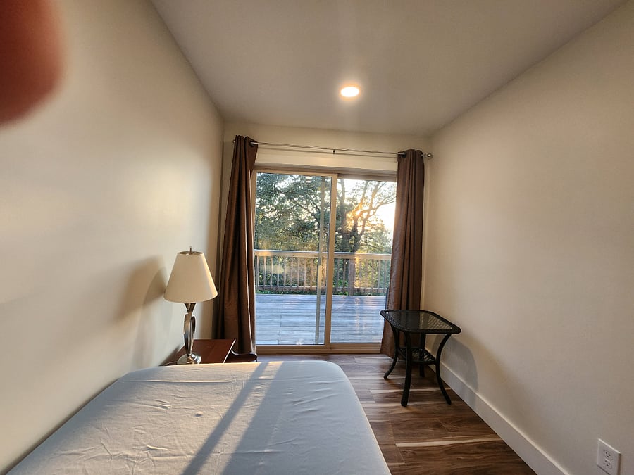 Small, single bedroom with deck access