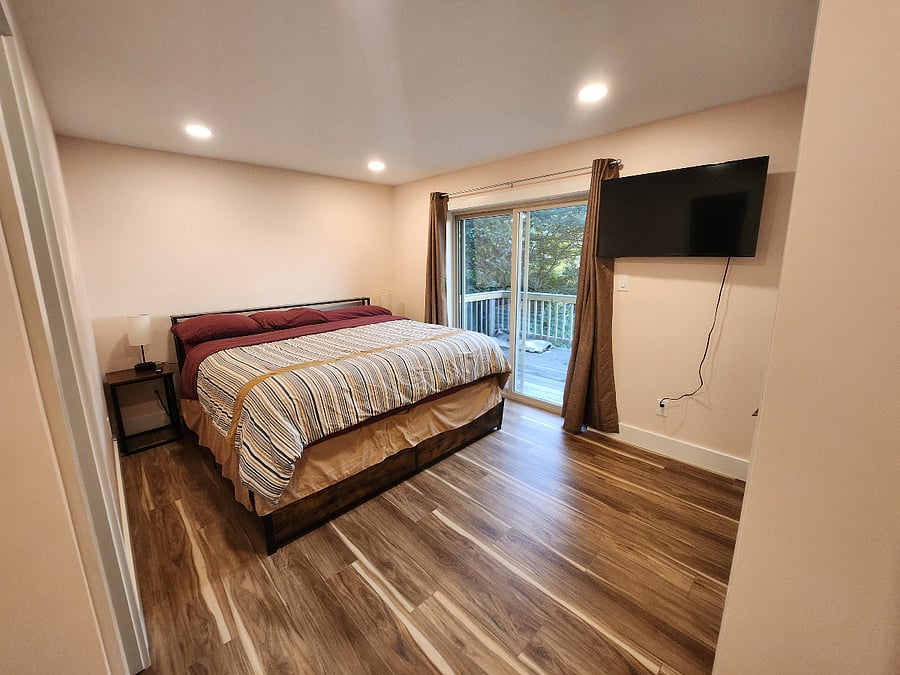 Master bedroom with king bed and exit to the deck