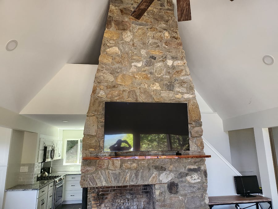 Smart TV in great room above fireplace