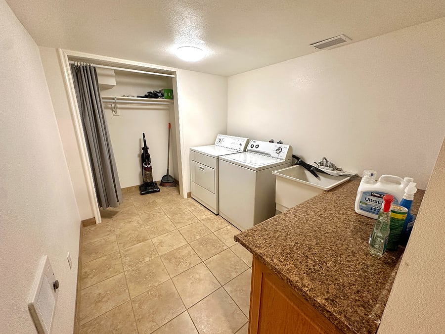 Laundry room with washer and dryer. Vaccuum, mop, and broom are included.