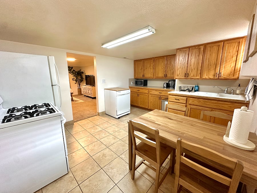 Well supplied kitchen with dishwasher, stove, fridge, and lots of storage. Basic cooking supplies like dishes and pots and pans are provided.