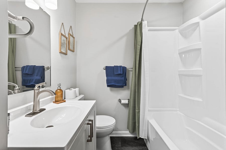 Mail level full bathroom with tub.