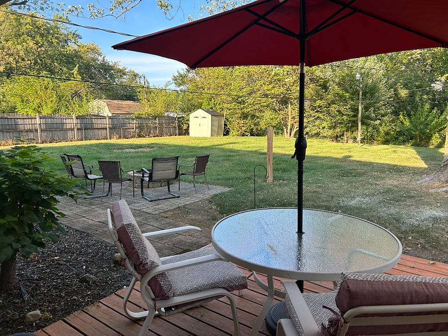 Backyard view with mini barn for additional storage